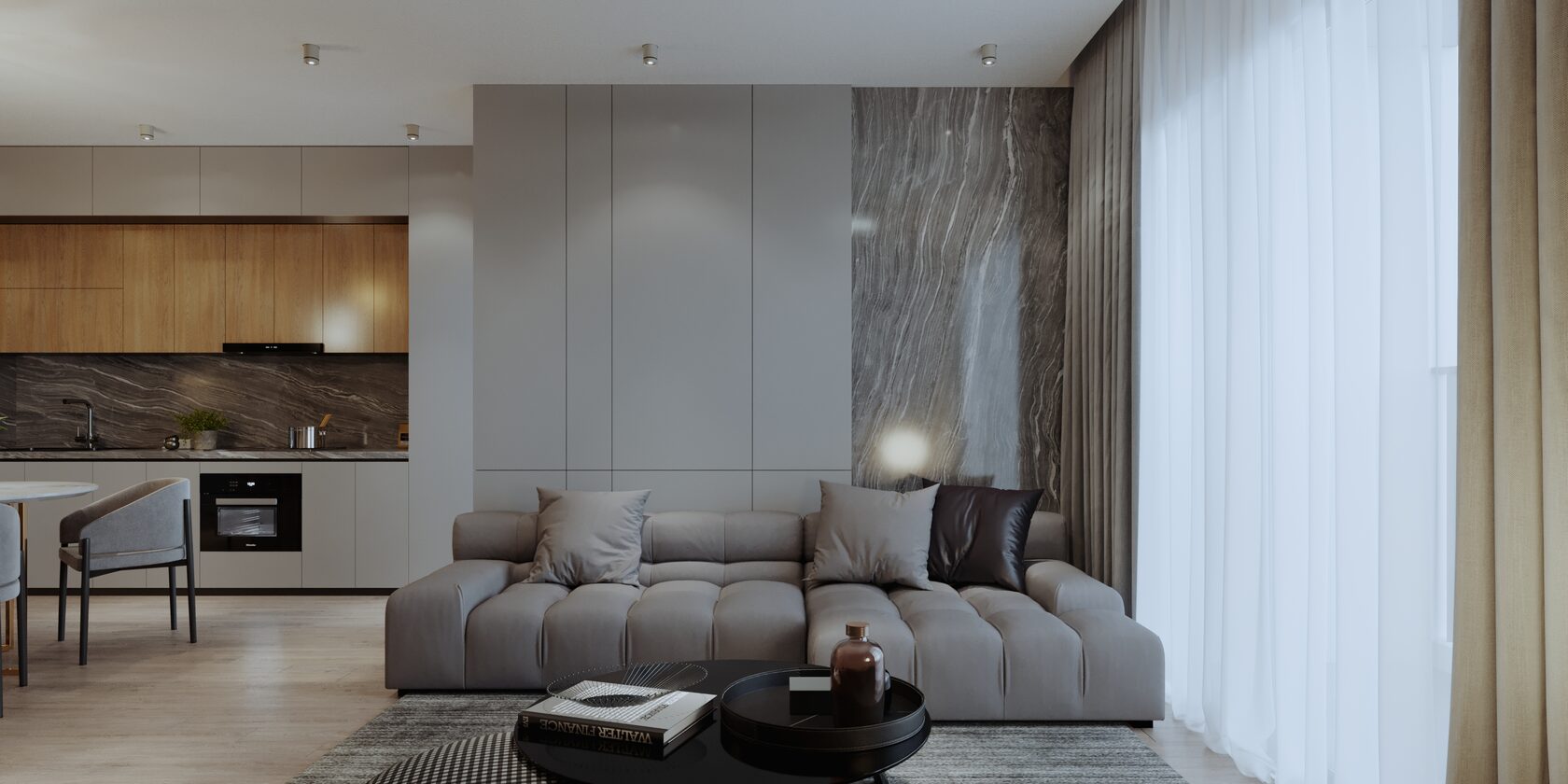 A modern living room with a sofa and a kitchen area